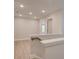 Upstairs hallway with light walls and wood-look flooring at 687 Sunstone Ln, Lawrenceville, GA 30043