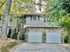 Two-story house with stone accents and a two-car garage at 997 Chartley Sw Dr, Lilburn, GA 30047