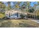 Brick ranch house with carport, well-manicured lawn, and mature trees at 4404 Mercer Rd, Decatur, GA 30035