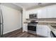 Modern kitchen with granite countertops and stainless steel appliances at 4404 Mercer Rd, Decatur, GA 30035