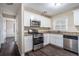 Updated kitchen featuring white cabinets, granite counters, and stainless steel appliances at 4404 Mercer Rd, Decatur, GA 30035