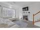 Living area with white sectional sofa, fireplace, and hardwood floors at 840 Minor Creek Nw Way, Lilburn, GA 30047