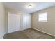 Well-lit bedroom with double closets and carpet flooring at 8775 Lee Rd, Lithia Springs, GA 30122