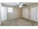 Bright bedroom with double closets and ceiling fan at 8775 Lee Rd, Lithia Springs, GA 30122