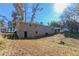 Rear view of a ranch house with a large backyard and partial basement at 8775 Lee Rd, Lithia Springs, GA 30122
