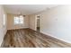 Bright living room featuring wood-look vinyl flooring and ceiling fan at 8775 Lee Rd, Lithia Springs, GA 30122