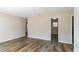 Spacious living room with wood-look floors at 8775 Lee Rd, Lithia Springs, GA 30122