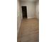 Bright bedroom featuring light wood laminate flooring and an adjacent doorway at 3066 Zodiac Ct, Lawrenceville, GA 30044