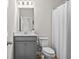 Bathroom with gray vanity, white toilet, and shower at 1049 Bodega Loop, Locust Grove, GA 30248