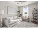 Bright bedroom with a sofa, rug, and decorative shelving at 1049 Bodega Loop, Locust Grove, GA 30248