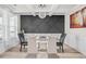 Elegant dining room with a statement wall and modern chandelier at 1049 Bodega Loop, Locust Grove, GA 30248