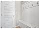 Entryway with bench, coat hooks, and white wainscoting at 1049 Bodega Loop, Locust Grove, GA 30248