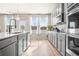 Modern kitchen with gray cabinets, stainless steel appliances, and hardwood floors at 1049 Bodega Loop, Locust Grove, GA 30248