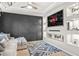Entertainment room with built-in shelving and a large TV at 1049 Bodega Loop, Locust Grove, GA 30248