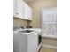 Laundry room with washer, dryer, and overhead cabinets at 2556 Lulworth Ln, Marietta, GA 30062