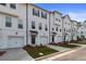 Row of townhouses with white exterior, black trim, and attached garages at 3218 Bateman Se Dr, Atlanta, GA 30354