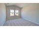 Well-lit bedroom with carpet and two windows at 184 Cabin Way, Hampton, GA 30228