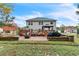 Brick patio with fire pit, grill, and landscaping at 3210 Avondale Pkwy, Powder Springs, GA 30127