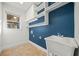 Laundry room with built-in shelving and utility sink at 5807 Ashleigh Walk Dr, Suwanee, GA 30024