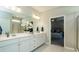 Double vanity bathroom with a shower and a view into the bedroom at 524 Lanier Way, Temple, GA 30179