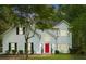 Two-story house with white siding, red door, and landscaping at 76 Barrington Parkway Pkwy, Sharpsburg, GA 30277