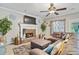 Spacious living room with a stone fireplace and comfortable sectional sofa at 76 Barrington Parkway Pkwy, Sharpsburg, GA 30277