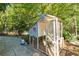 White chicken coop in the backyard, nestled in a garden setting at 315 Vickers Ne Dr, Atlanta, GA 30307