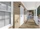 Inviting front porch with white railing and security door at 1477 Akridge Nw St, Atlanta, GA 30314