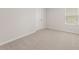 Spacious bedroom with carpeted floors and window at 7037 Brushwood Bend, Lithonia, GA 30058