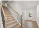 Carpeted staircase with metal railing leading to the second floor at 7037 Brushwood Bend, Lithonia, GA 30058