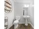 Powder room with pedestal sink and modern toilet at 2132 Shadygrove Walk, Austell, GA 30168