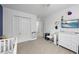 bedroom with white walls, crib, and dresser at 2132 Shadygrove Walk, Austell, GA 30168