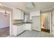 White kitchen with gray countertops and patterned floor at 6209 Bishop Pl, Riverdale, GA 30296