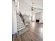 Living room featuring wood-look floors, high ceilings, fireplace, and staircase at 1265 Watercrest Cir, Lawrenceville, GA 30043