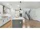 Open concept kitchen with white cabinets, stainless steel appliances, and hardwood floors at 469 Maypop Ln, Woodstock, GA 30188