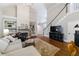 Spacious living room featuring built-in shelving, fireplace, and hardwood floors at 108 Ardsley Run, Canton, GA 30115