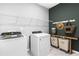 Laundry room features washer, dryer and stylish wood shelf at 2098 Amaryllis Dr, Grayson, GA 30017