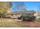 Backyard with a brick patio and mature trees, covered in fall leaves at 896 Meadow Rock Way, Stone Mountain, GA 30083