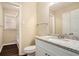Bathroom with granite vanity, white cabinets, and shower/tub combo at 896 Meadow Rock Way, Stone Mountain, GA 30083