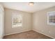 Unfurnished bedroom with carpet, windows, and soft, neutral-toned walls at 896 Meadow Rock Way, Stone Mountain, GA 30083