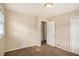 Empty, carpeted bedroom with neutral walls, closet, and doorway at 896 Meadow Rock Way, Stone Mountain, GA 30083