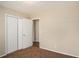 Empty bedroom with plush carpet, closet, and several doors at 896 Meadow Rock Way, Stone Mountain, GA 30083
