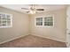 Empty bedroom with carpet, ceiling fan, and windows with blinds at 896 Meadow Rock Way, Stone Mountain, GA 30083