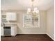 Dining area with wood-look floors, a chandelier, and windows overlooking the backyard at 896 Meadow Rock Way, Stone Mountain, GA 30083