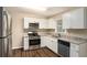 Modern kitchen featuring white shaker cabinets, stainless steel appliances, and granite countertops at 896 Meadow Rock Way, Stone Mountain, GA 30083