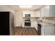 Updated kitchen with white cabinets, granite counters, and stainless steel appliances at 896 Meadow Rock Way, Stone Mountain, GA 30083
