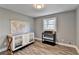 Well-lit Bedroom with hardwood floors, crib, changing table, and a window at 3031 San Jose Dr, Decatur, GA 30032