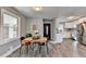 Modern dining area with wood flooring and view into kitchen and living room at 3031 San Jose Dr, Decatur, GA 30032