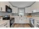 Modern kitchen with white cabinets, stainless steel appliances, and quartz countertops at 3031 San Jose Dr, Decatur, GA 30032