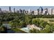 Aerial view of a city skyline with a park, lake, and pool at 975 Piedmont Ne Ave # 1, Atlanta, GA 30309